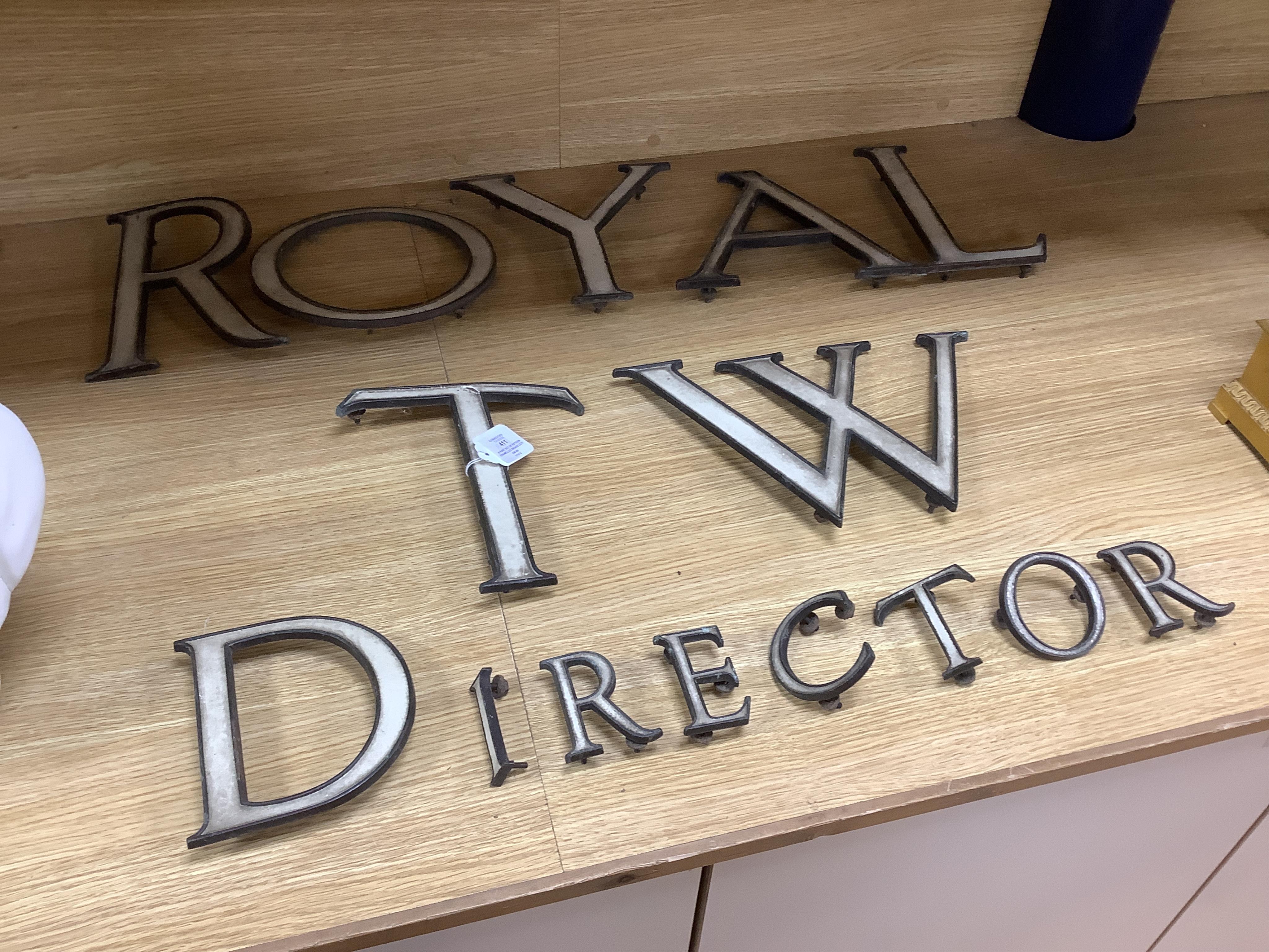 A part set of fifteen enamelled brass letters, largest 23cm
